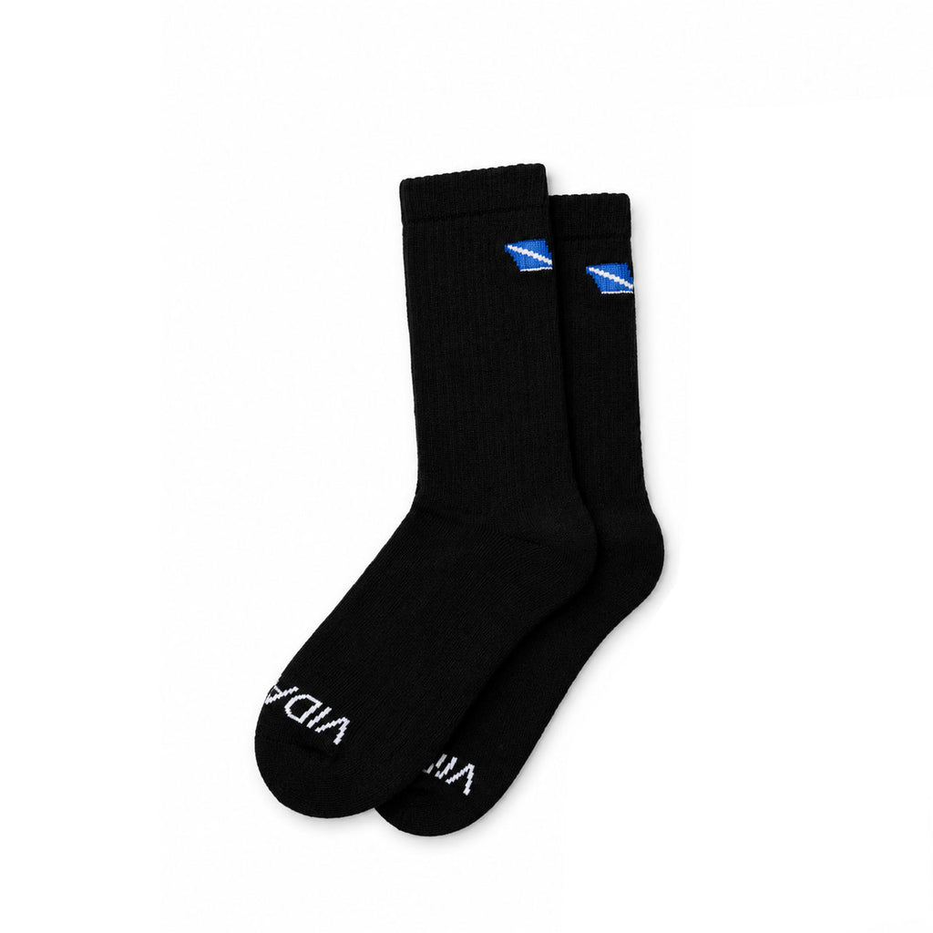 A pair of black crew socks with a small blue and white logo near the cuff and white text on the toes, displayed against a solid white background.